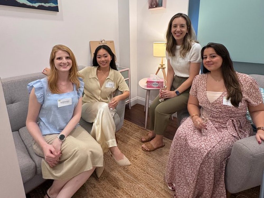 Dr Marie-Claire Reville sitting with colleagues